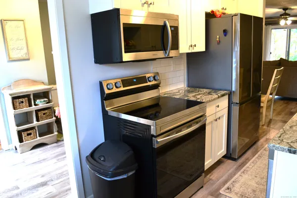 a kitchen with stainless steel appliances a stove and a microwave