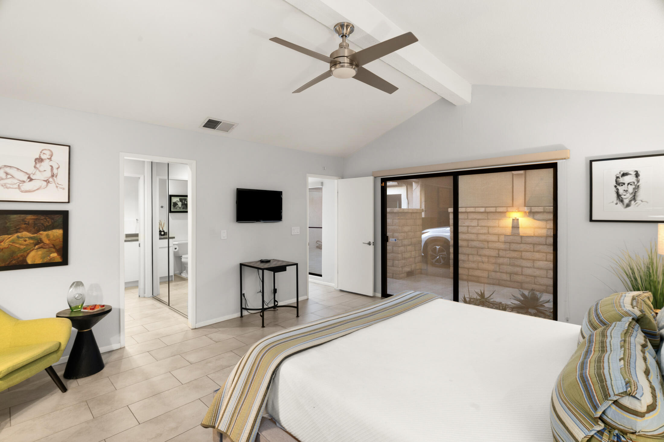 6155 East Driver Road Palm Springs, CA 92264 - Photo 11 of 22 a bedroom with a bed and large mirror with a flat tv screen