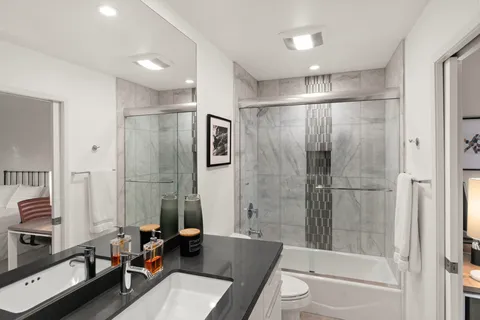 a bathroom with a granite countertop sink and a mirror