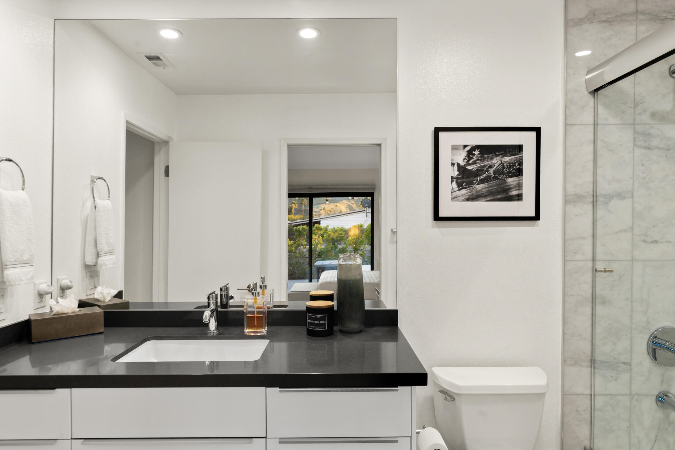 6155 East Driver Road Palm Springs, CA 92264 - Photo 14 of 22 a bathroom with a granite countertop sink and a mirror