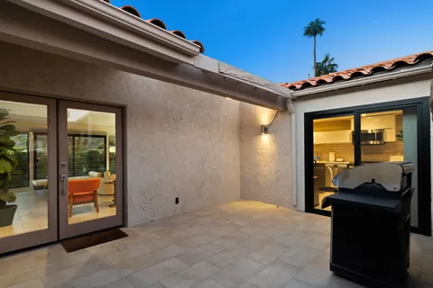a view of a house with a large tree and a yard