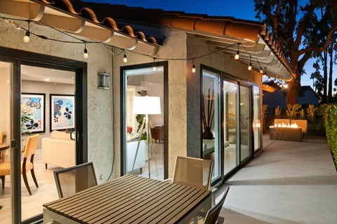 a front view of a house with a yard and mountain view