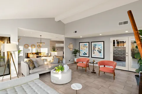 a living room with furniture and wooden floor