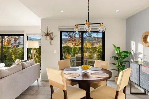 a view of a dining room with furniture window and outside view