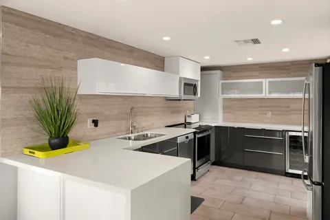 a kitchen with a sink appliances and cabinets