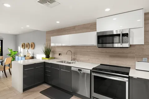 a kitchen with a sink stove and microwave