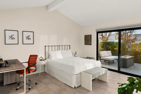 a bedroom with a bed and a large window