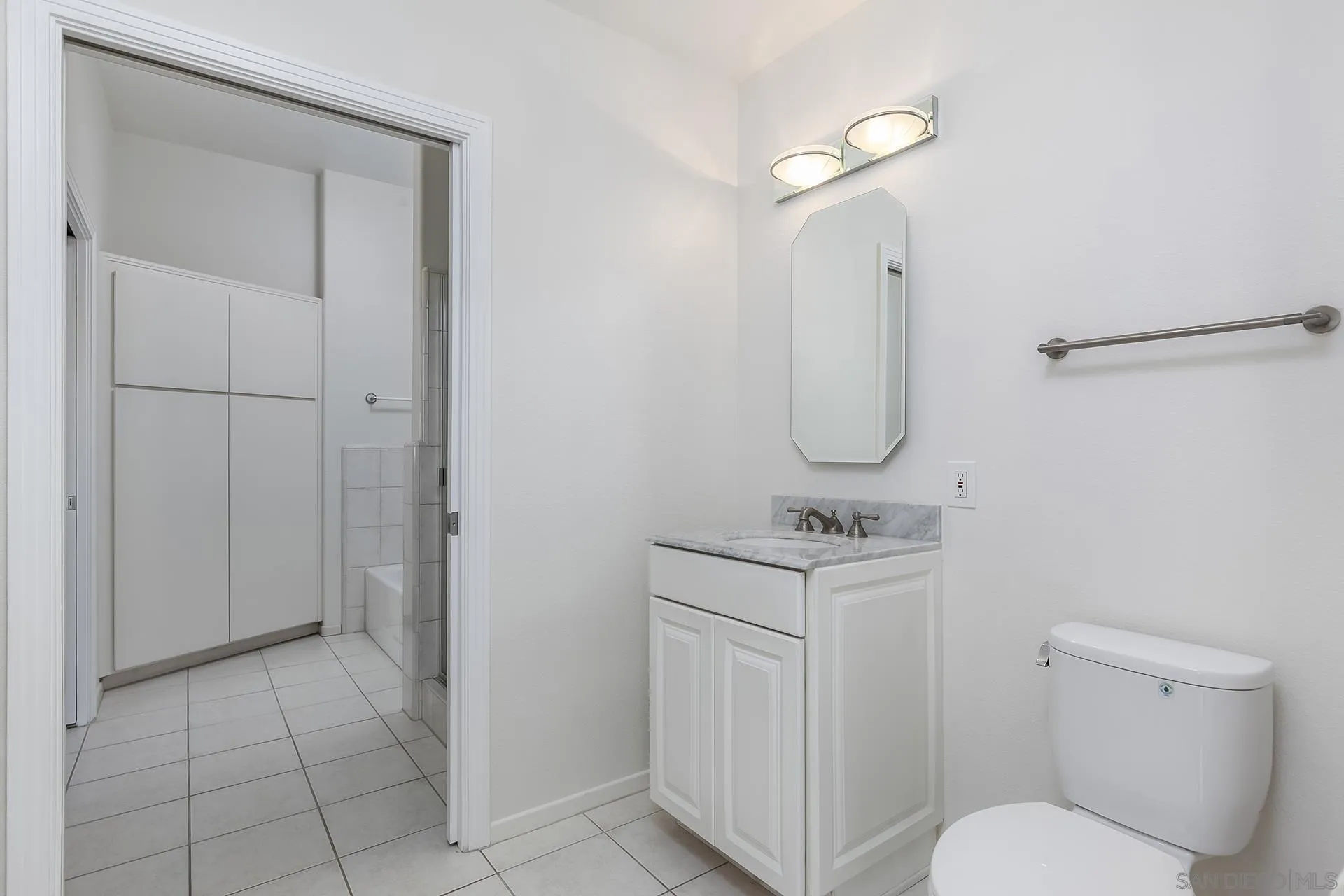 611 West G Street, Unit 321 San Diego, CA 92101 - Photo 20 of 28 a bathroom with a toilet a sink and mirror