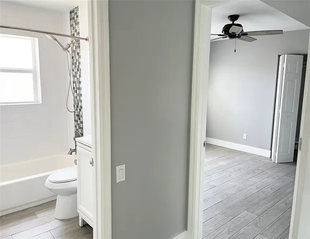 a bathroom with a granite countertop sink mirror vanity and toilet