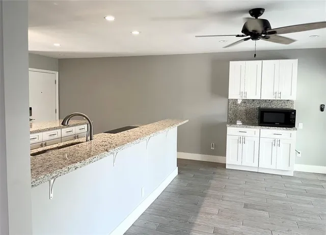 a view of a kitchen with a sink and cabinet