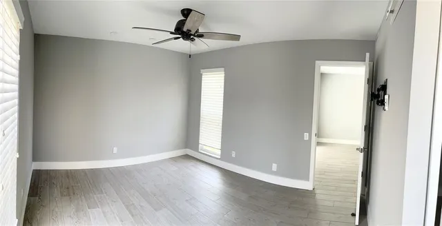 a view of an empty room and wooden floor