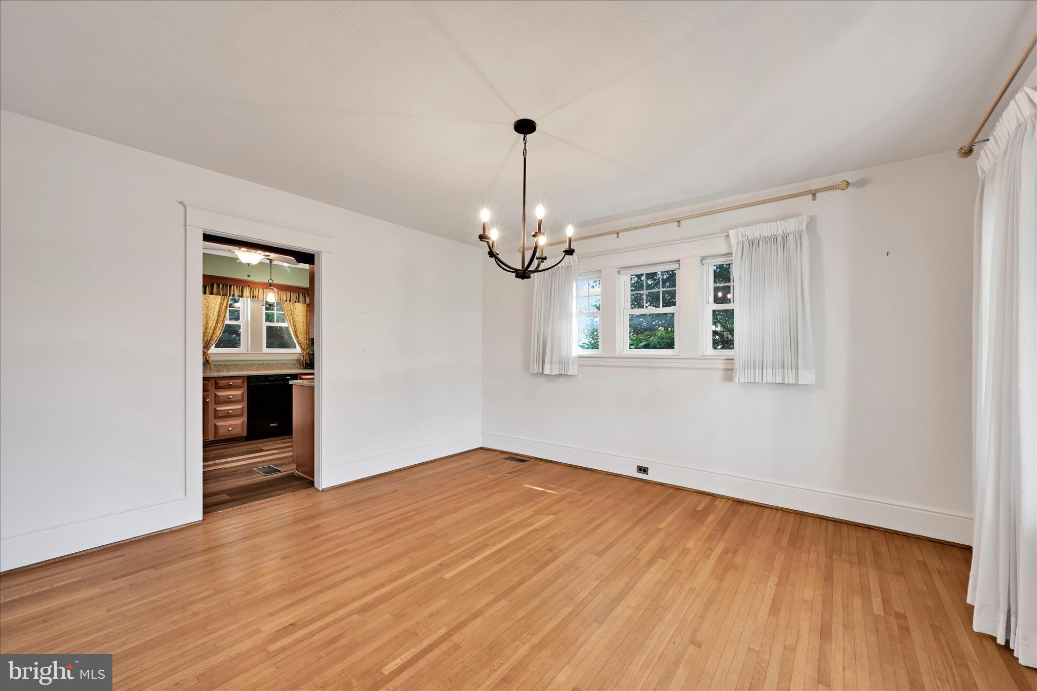 715 South Main Street Red Lion, PA 17356 - Photo 11 of 44 a view of empty room with wooden floor fireplace and window
