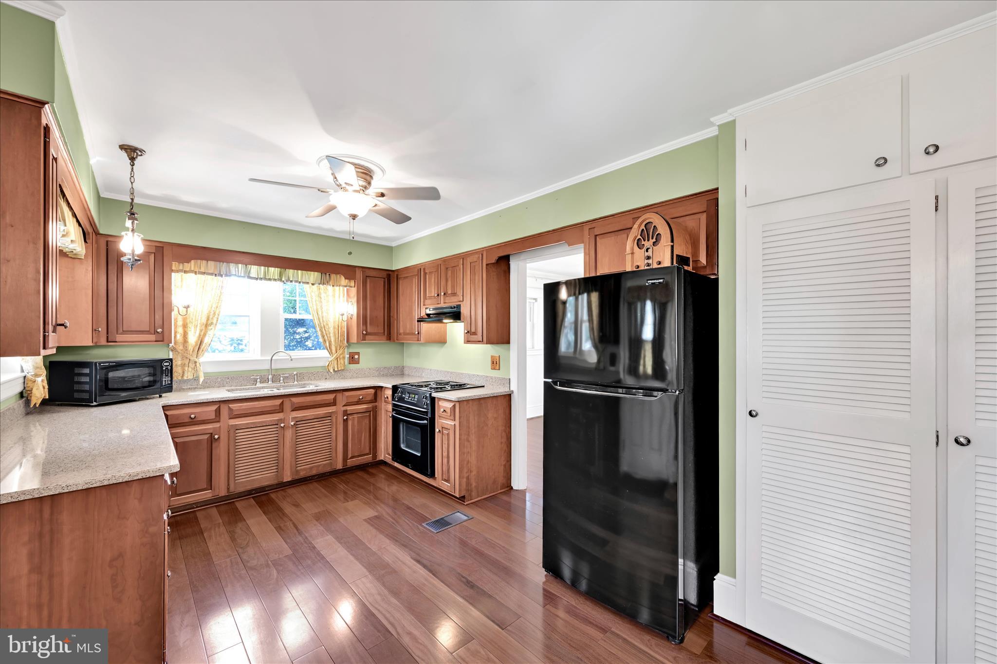 715 South Main Street Red Lion, PA 17356 - Photo 15 of 44 a kitchen with refrigerator a sink dishwasher with a dining table and chairs