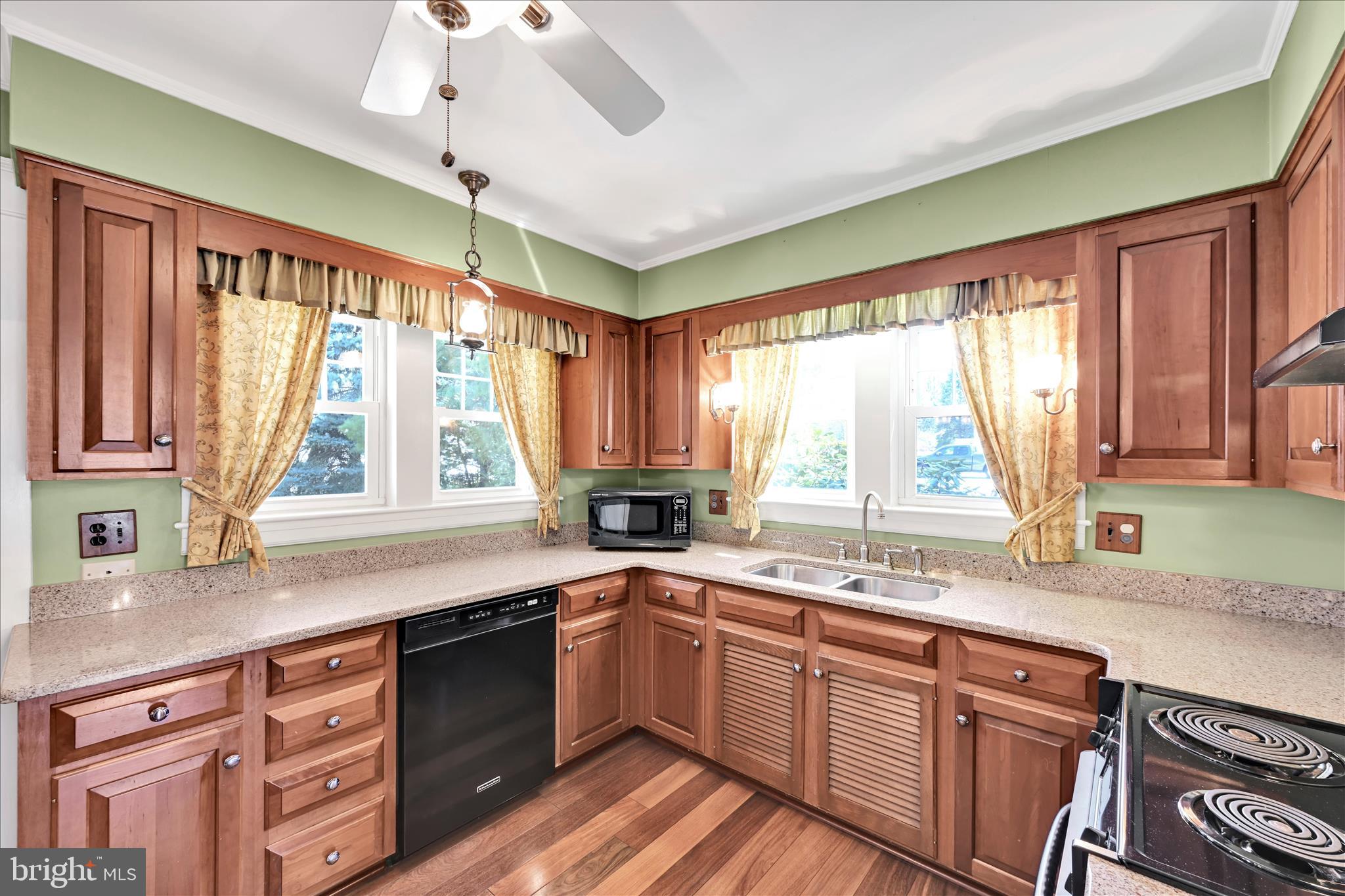 715 South Main Street Red Lion, PA 17356 - Photo 18 of 44 a kitchen with stainless steel appliances granite countertop a sink a stove cabinets counter space and a large window