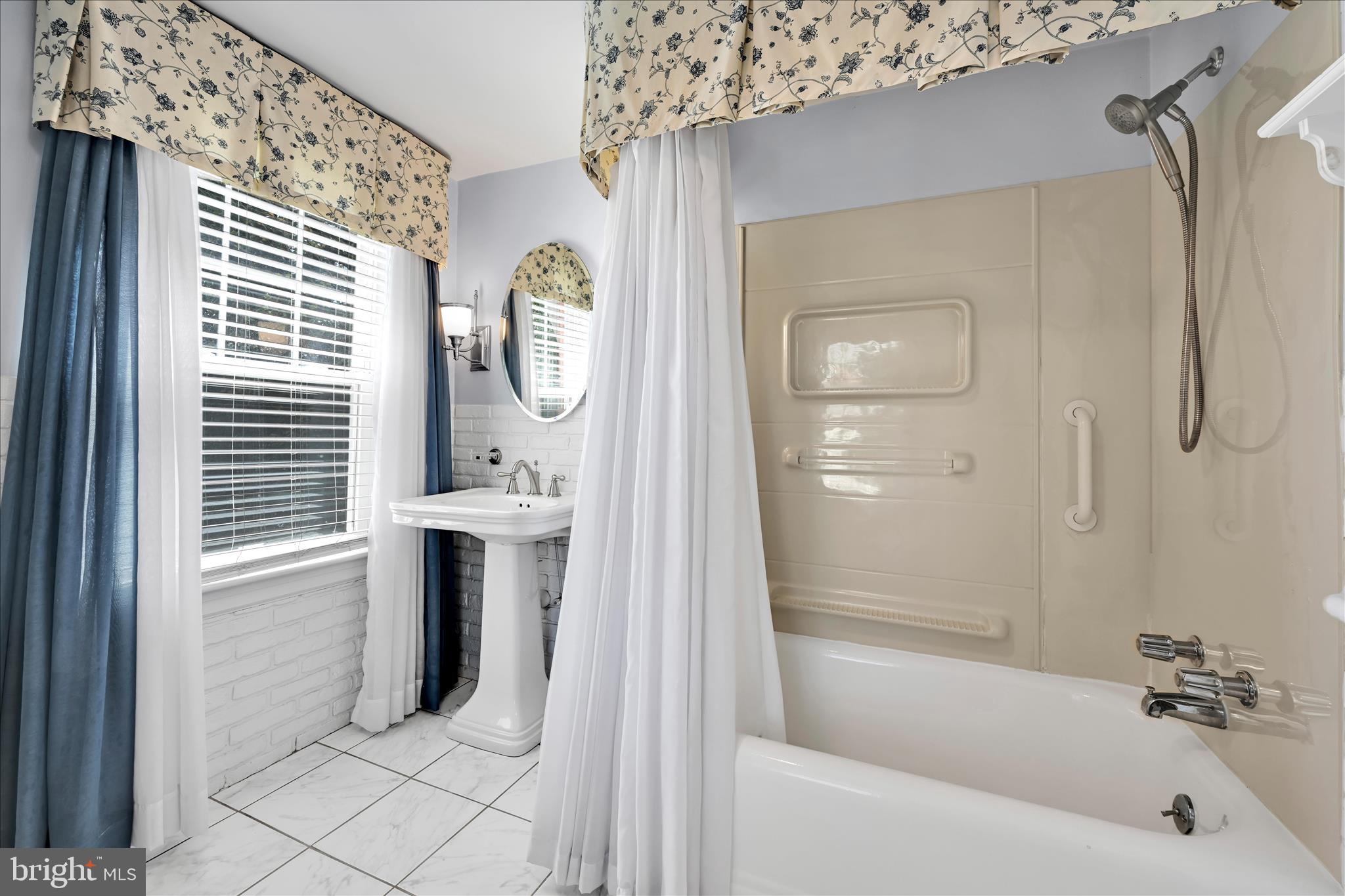 715 South Main Street Red Lion, PA 17356 - Photo 25 of 44 a bathroom with a tub a sink and a window