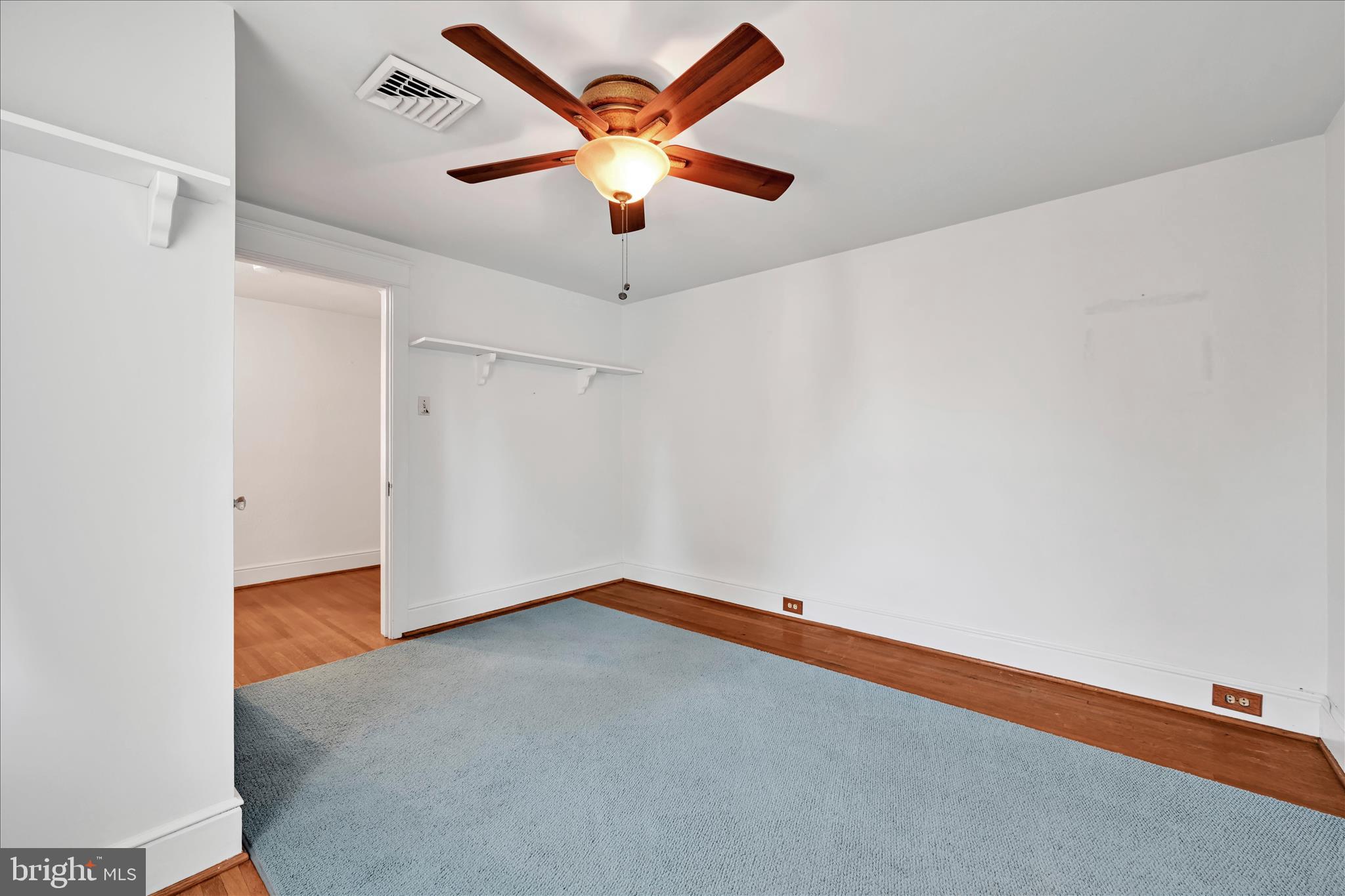 715 South Main Street Red Lion, PA 17356 - Photo 28 of 44 an empty room with a ceiling fan and wooden floor