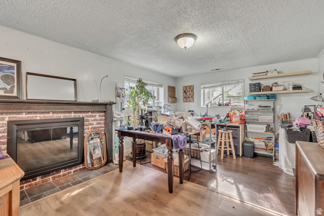 7470 Ramanee Drive Midvale, UT 84047 - Photo 22 of 29 Flex space can be a large bedroom with walk in closet or as a family room, a textured ceiling, and a brick fireplace