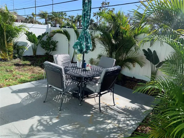 a view of a backyard with a patio and outdoor seating
