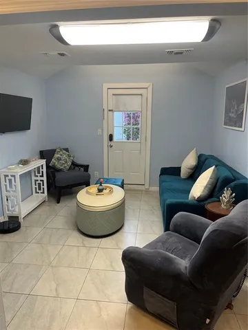 a living room with furniture and a mirror