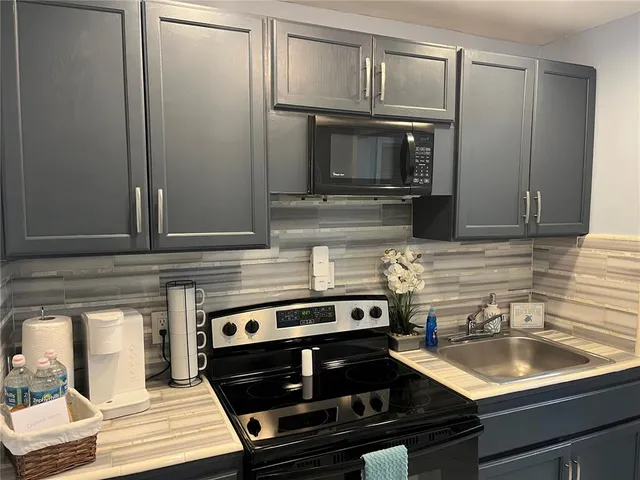 a kitchen with a stove and a microwave