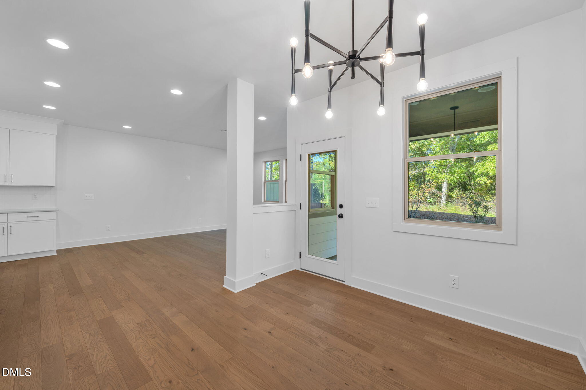 968 Double Helix Road Apex, NC 27523 - Photo 4 of 44 an empty room with wooden floor and windows
