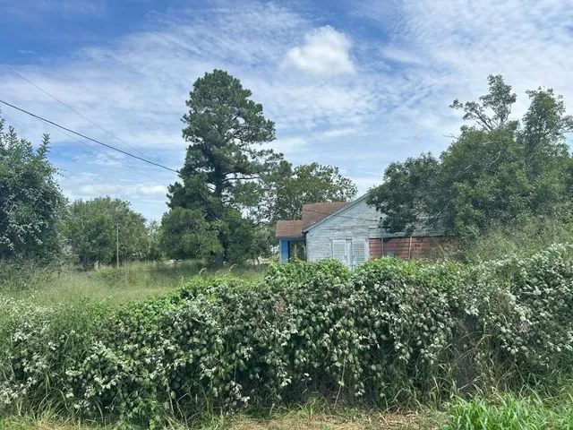 an aerial view of a house with a yard