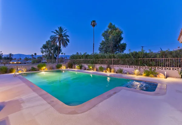 a view of a swimming pool and a yard