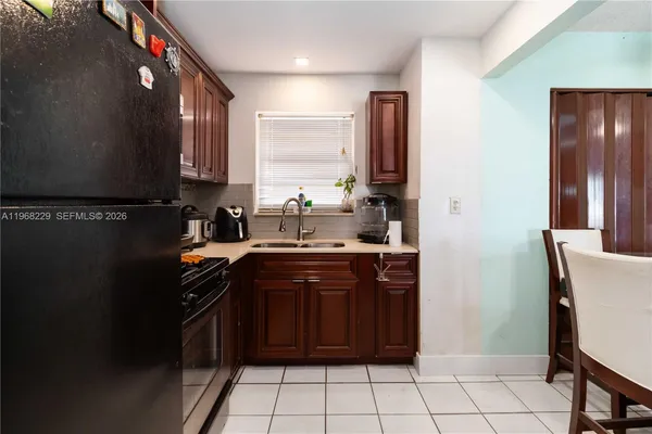 a kitchen with a sink stove and refrigerator