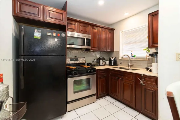 a kitchen with stainless steel appliances granite countertop a refrigerator and a sink