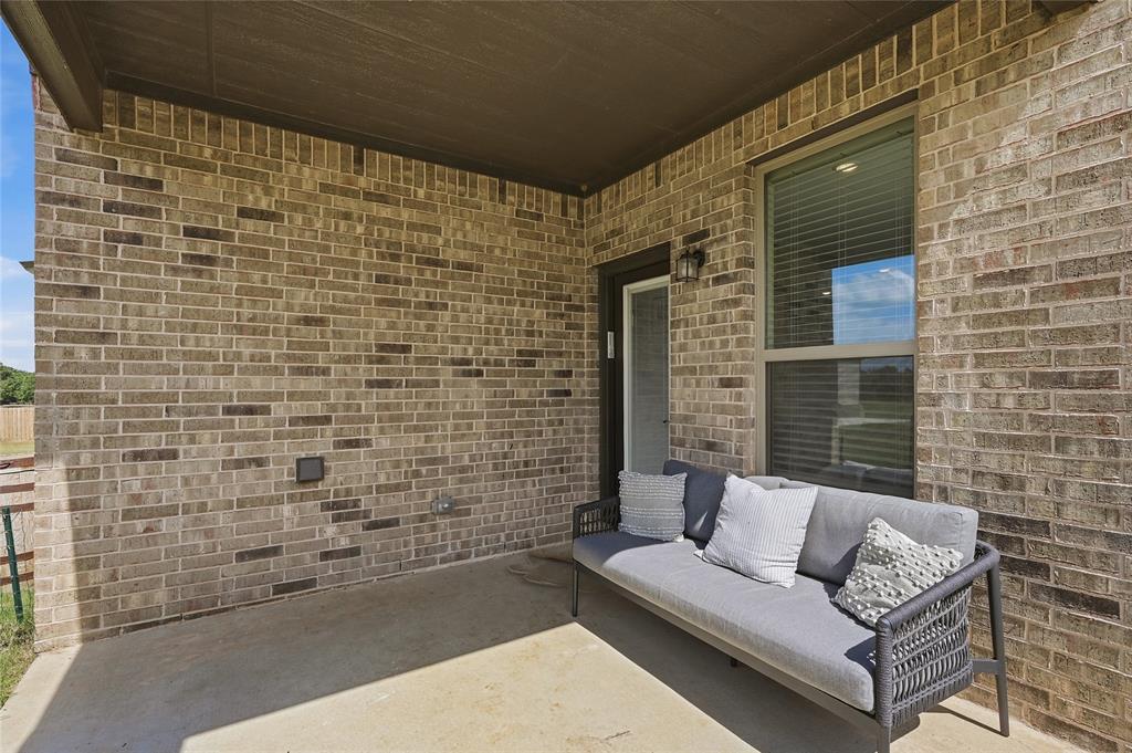 864 Shadow Valley Road Whitesboro, TX 76273 - Photo 40 of 40 Covered patio featuring a concrete slab and a brick exterior wall