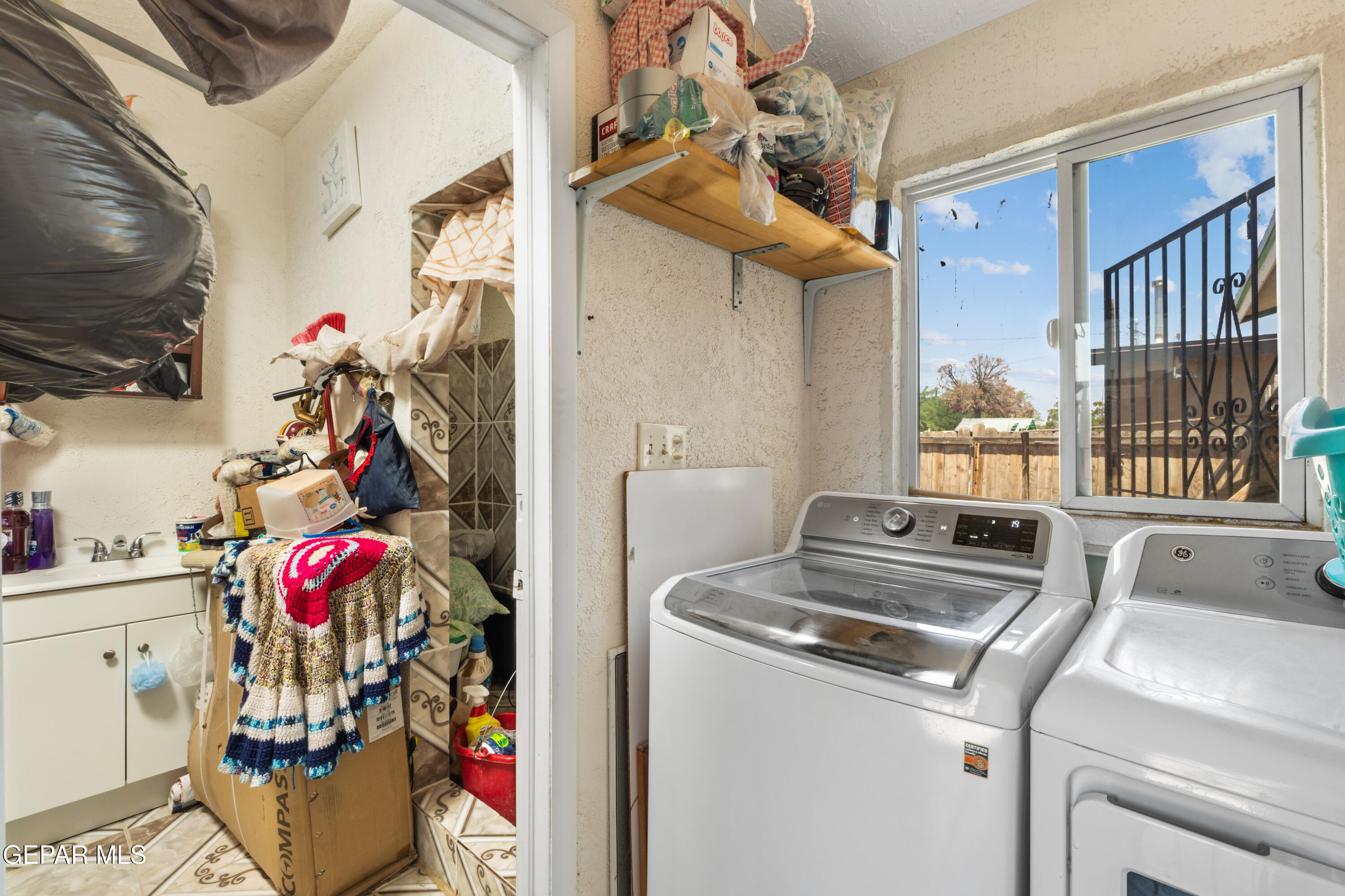 219 Polo Inn Road El Paso, TX 79915 - Photo 16 of 25 a utility room with dryer washer and a view of living room