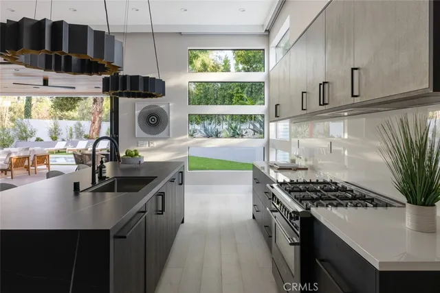a kitchen with a sink and a stove top oven