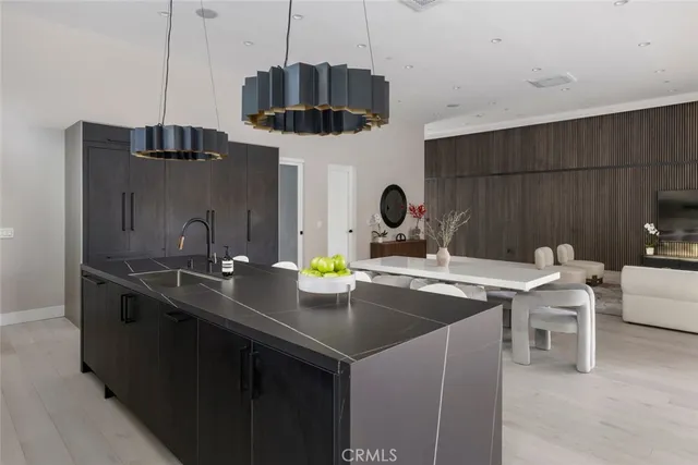 a kitchen with a sink a stove and cabinets