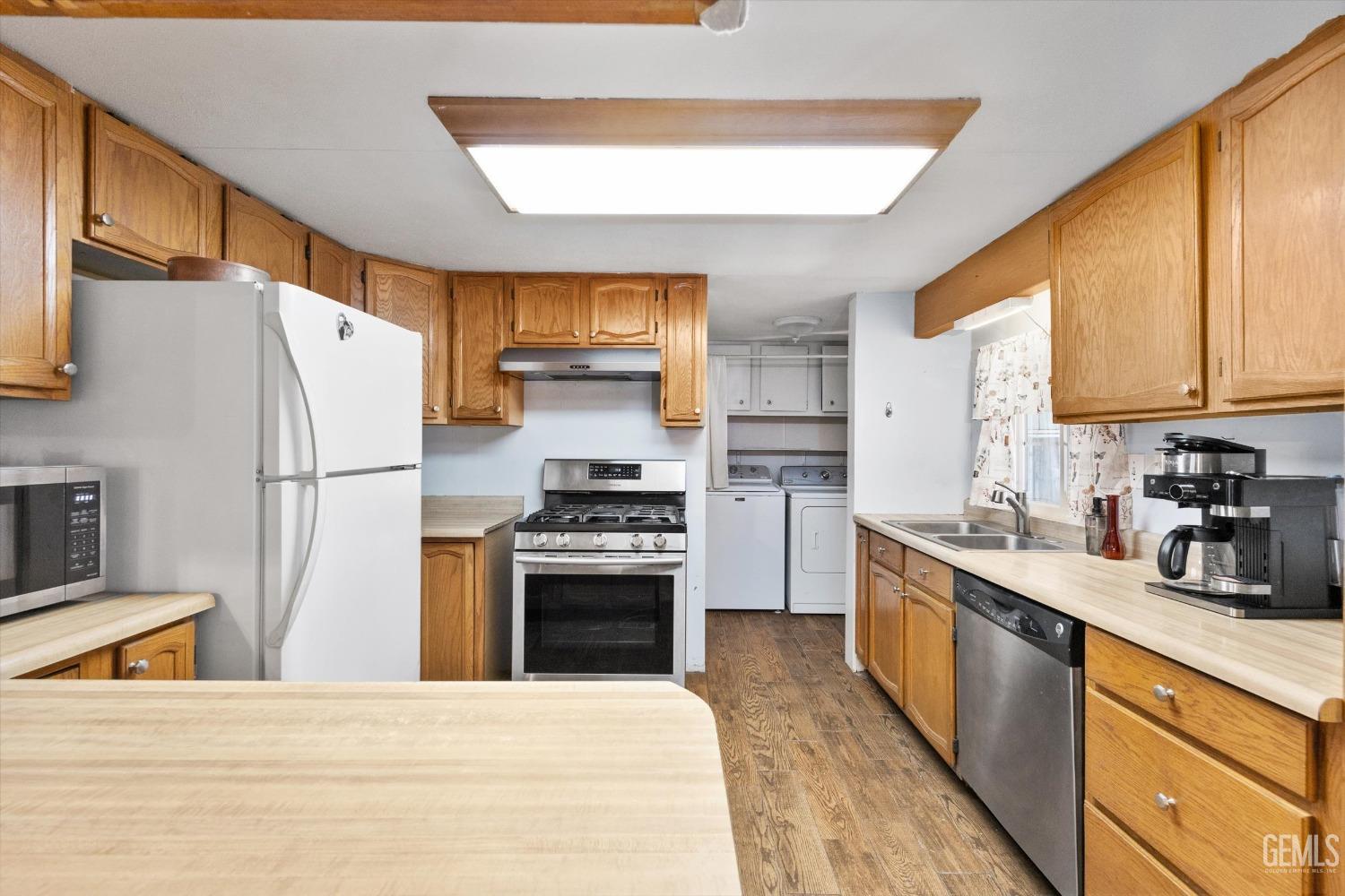 Undisclosed Address Bakersfield, CA 93314 - Photo 12 of 34 a kitchen with stainless steel appliances granite countertop a refrigerator a stove a sink and a refrigerator