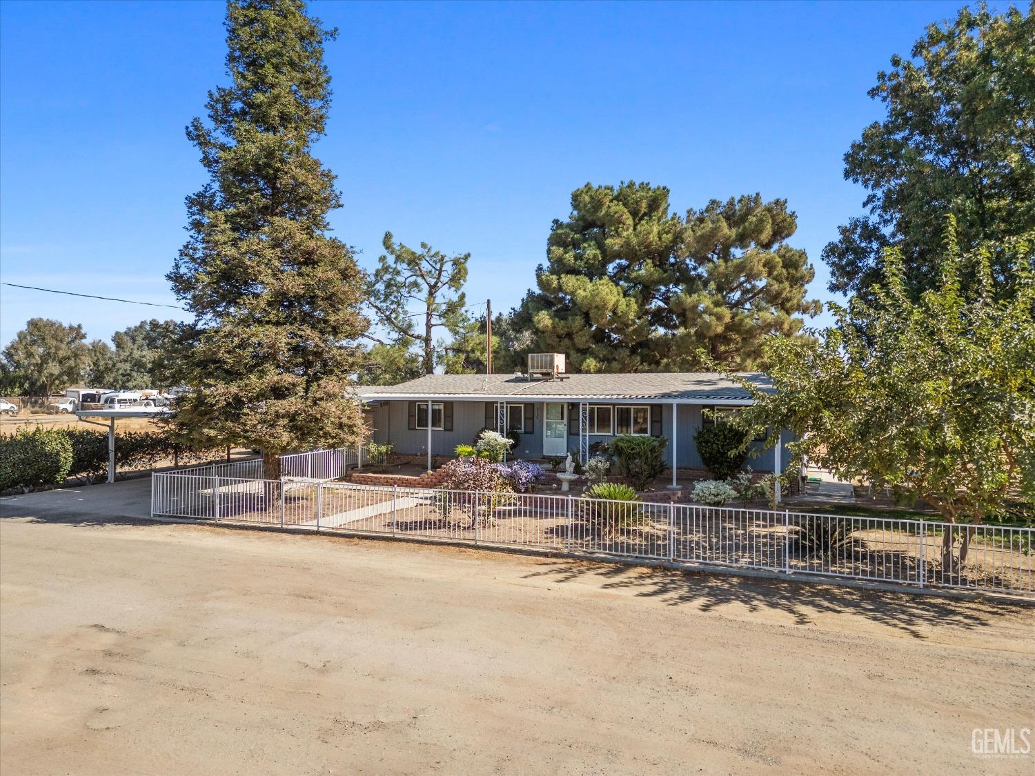 Undisclosed Address Bakersfield, CA 93314 - Photo 4 of 34 a front view of a house with yard patio and fire pit