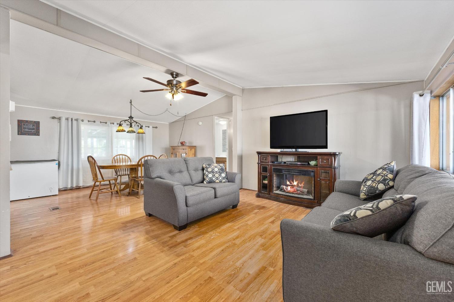 Undisclosed Address Bakersfield, CA 93314 - Photo 6 of 34 a living room with furniture and a flat screen tv
