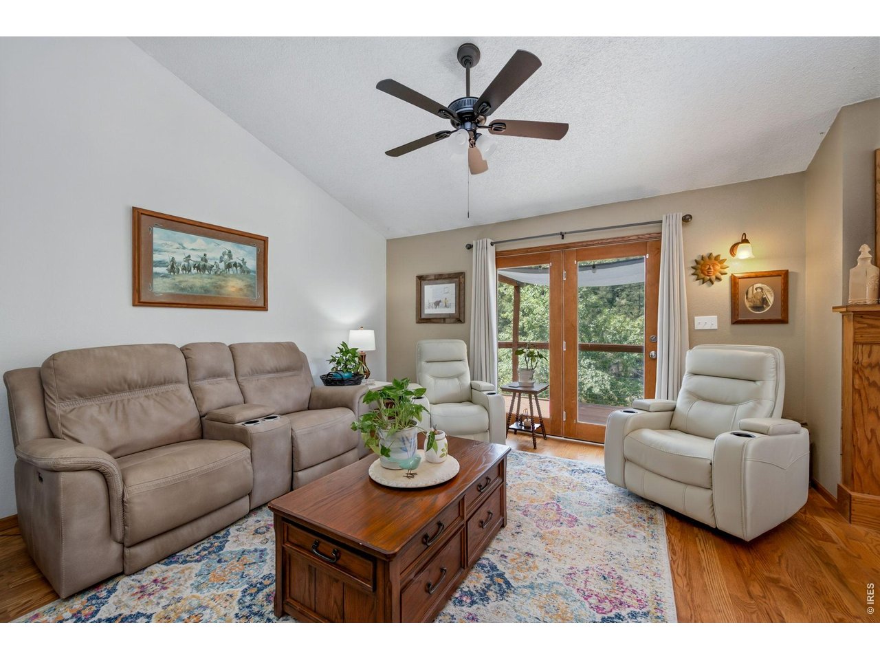 1154 Spring Valley Road Bellvue, CO 80512 - Photo 8 of 31 14x15 living room with beautiful hardwood floors, a vaulted ceiling and french doors out to the deck, which looks over the pond. Just out of frame is a wood burning, custom fire place
