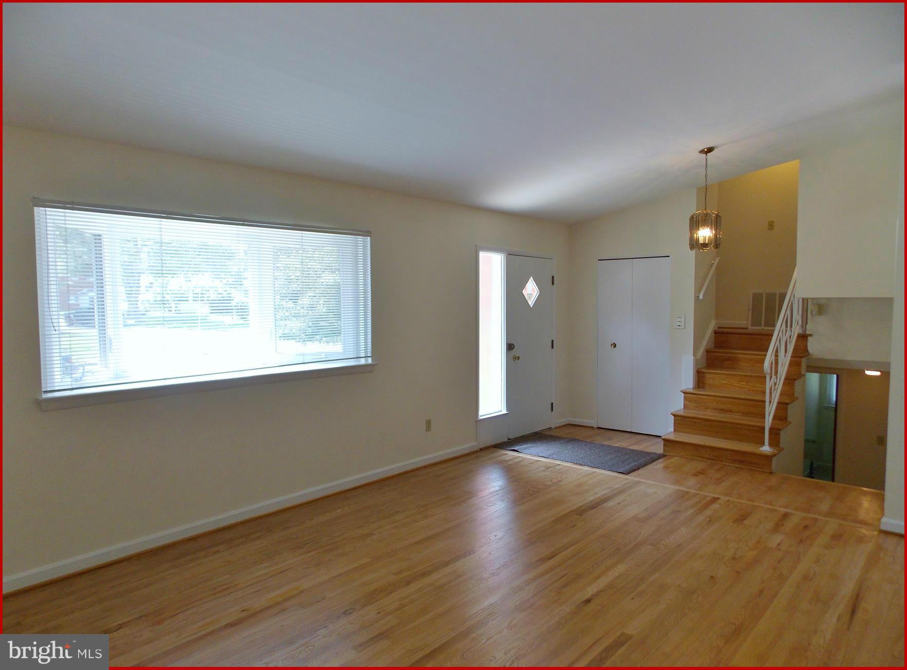 1615 Ladd Street Silver Spring, MD 20902 - Photo 2 of 30 a view of an empty room with wooden floor and stairs