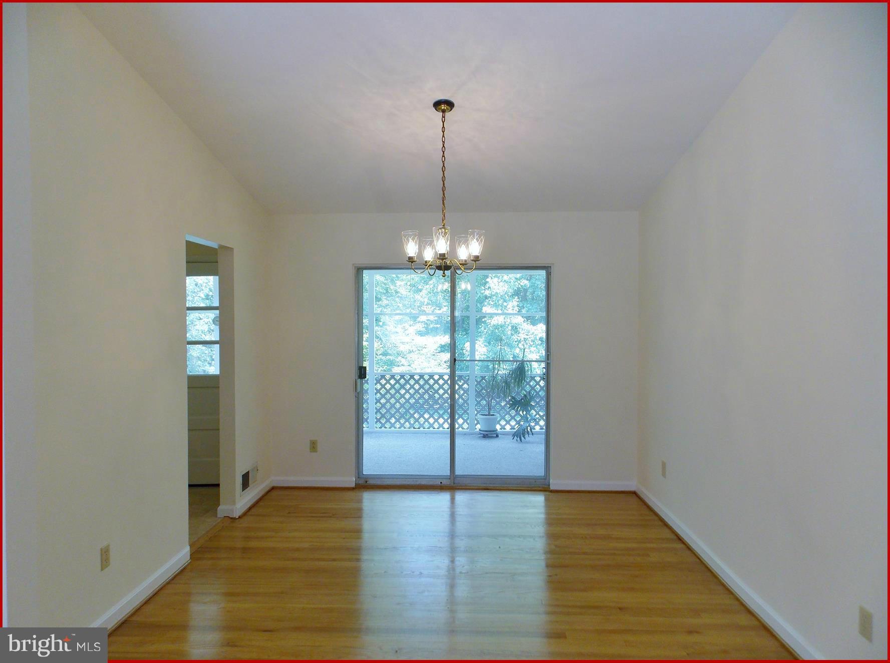1615 Ladd Street Silver Spring, MD 20902 - Photo 5 of 30 a view of an empty room with glass door and wooden floor