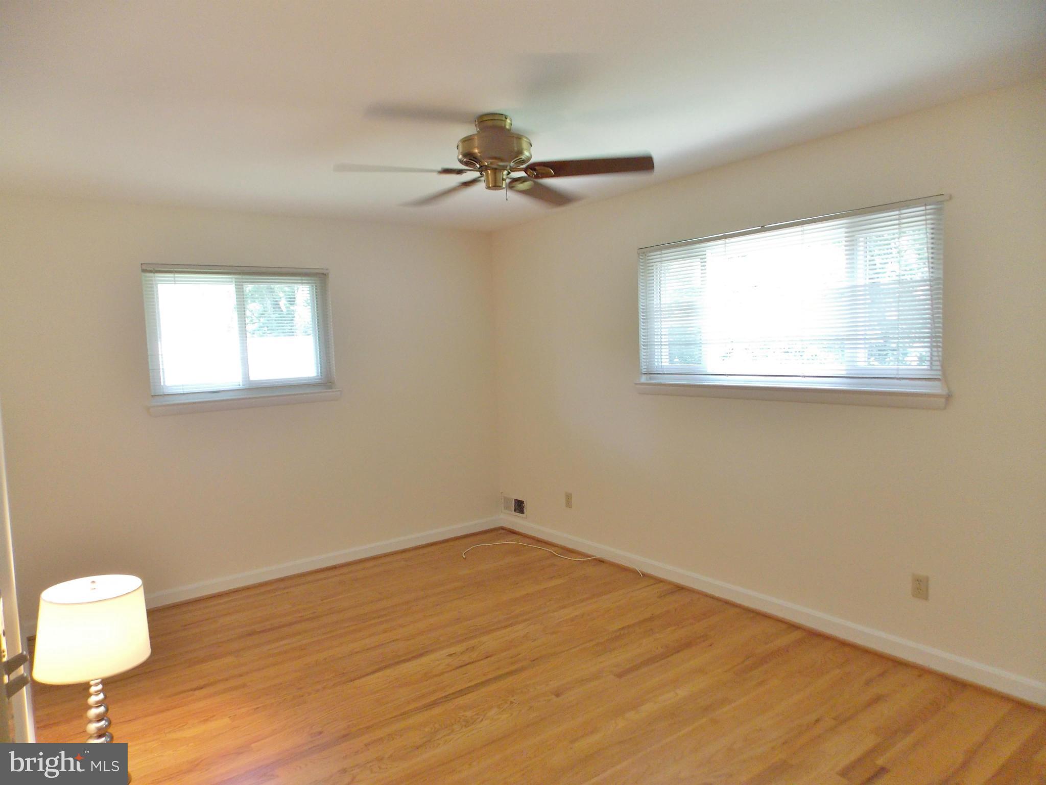 1615 Ladd Street Silver Spring, MD 20902 - Photo 6 of 30 a view of an empty room with a window and wooden floor
