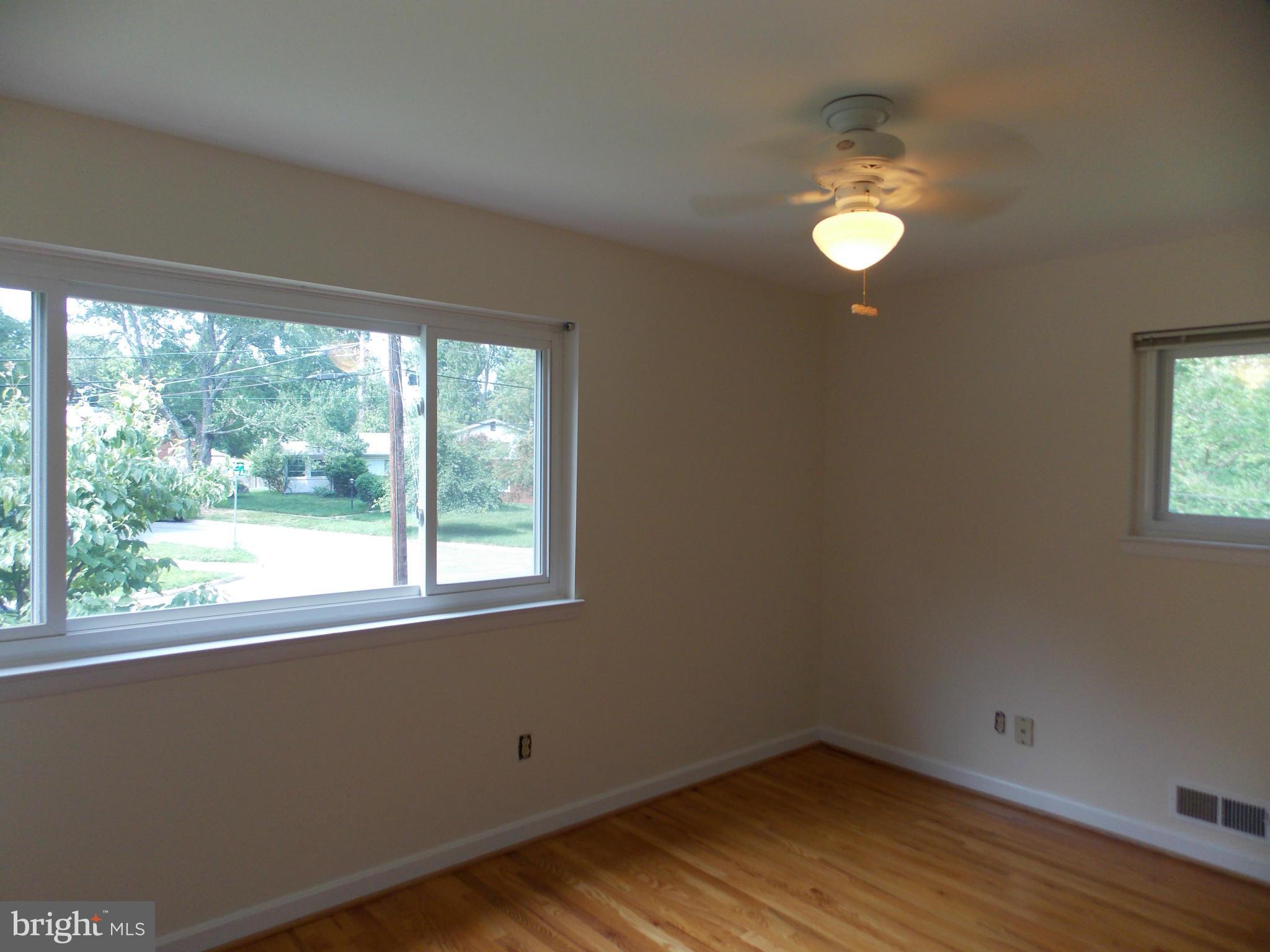 1615 Ladd Street Silver Spring, MD 20902 - Photo 9 of 30 an empty room with wooden floor and windows