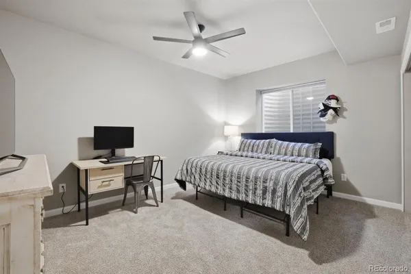 a bedroom with a bed and a desk