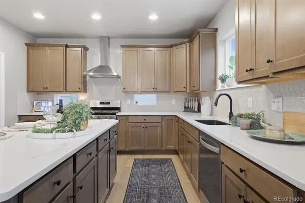 a kitchen with granite countertop white cabinets and white appliances