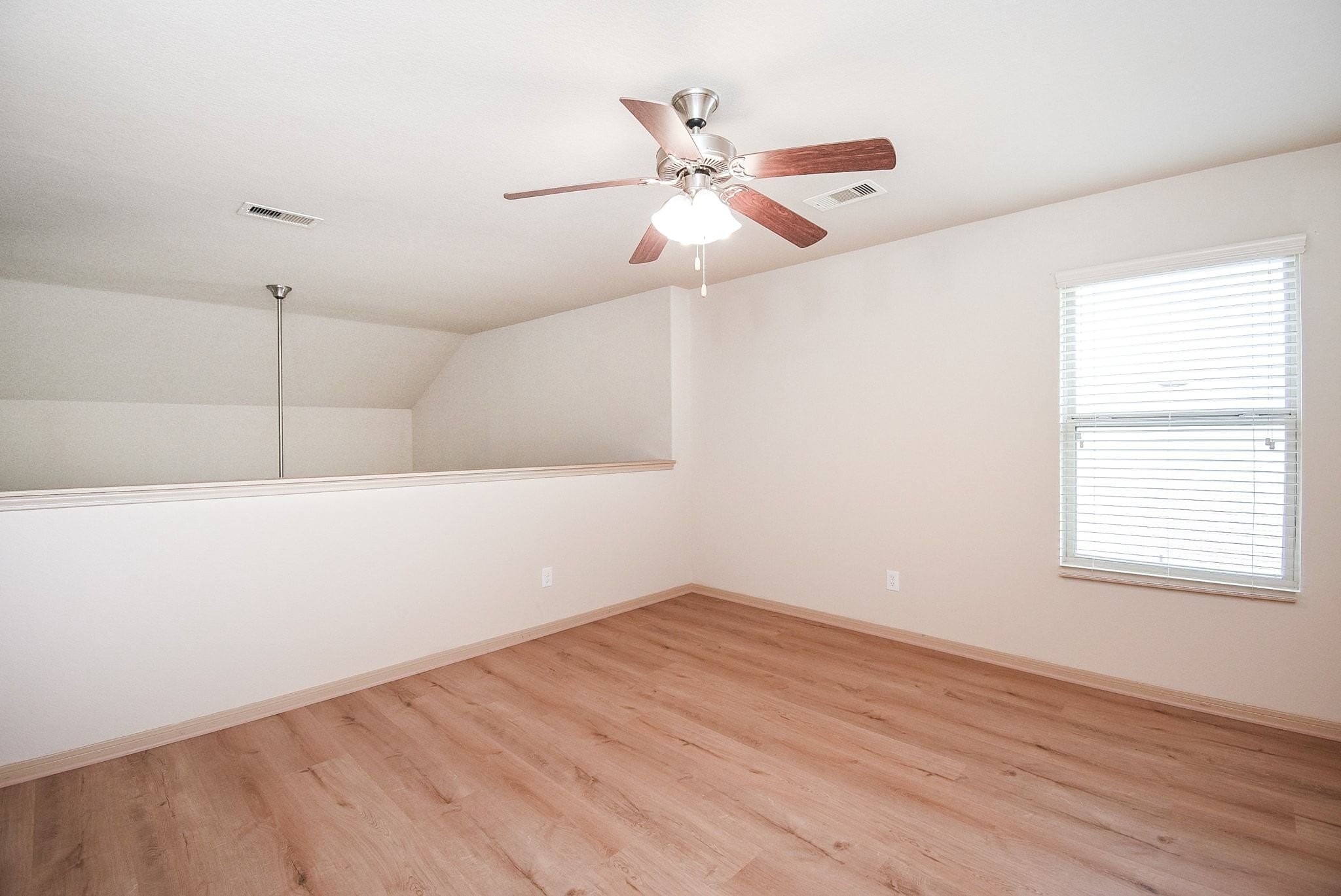 2106 Harmon Crest Court Spring, TX 77373 - Photo 28 of 37 an empty room with wooden floor fan and windows