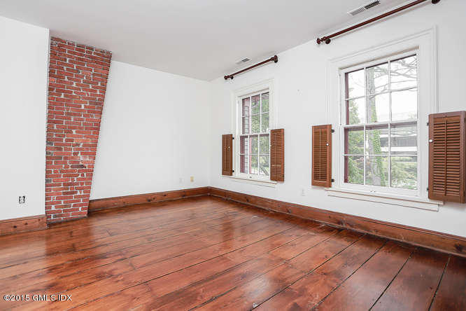 603 Steamboat Road, Unit 1 Greenwich, CT 06830 - Photo 12 of 20 a view of an empty room with wooden floor and a window
