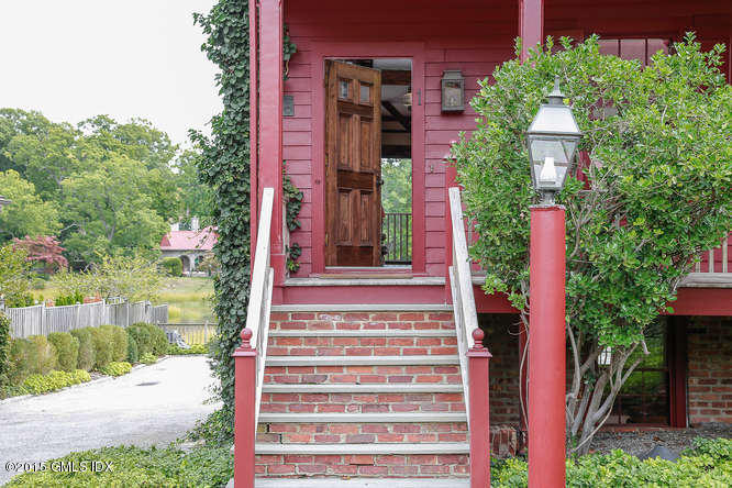 603 Steamboat Road, Unit 1 Greenwich, CT 06830 - Photo 3 of 20 a front view of a house with a yard