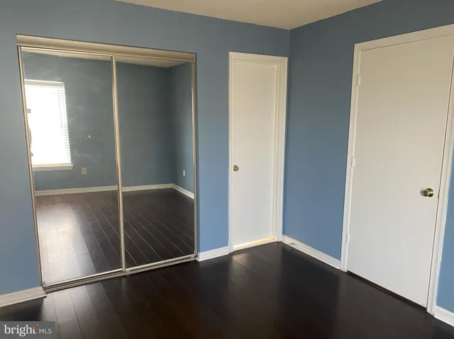 a view of closet area with wooden floor
