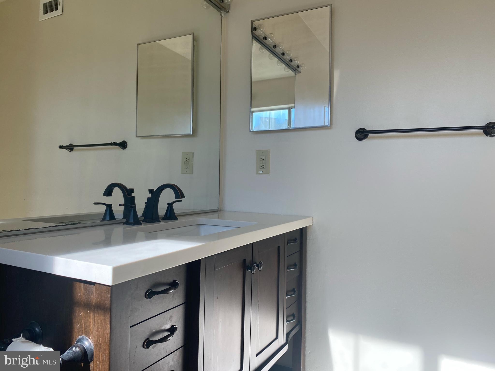 14119 Bowsprit Lane, Unit 312 Laurel, MD 20707 - Photo 15 of 24 a kitchen with a sink and cabinets