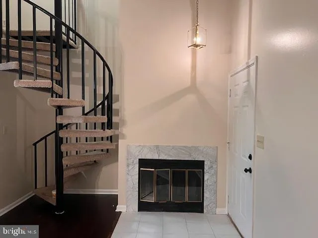 a view of a livingroom with wooden floor and a fireplace
