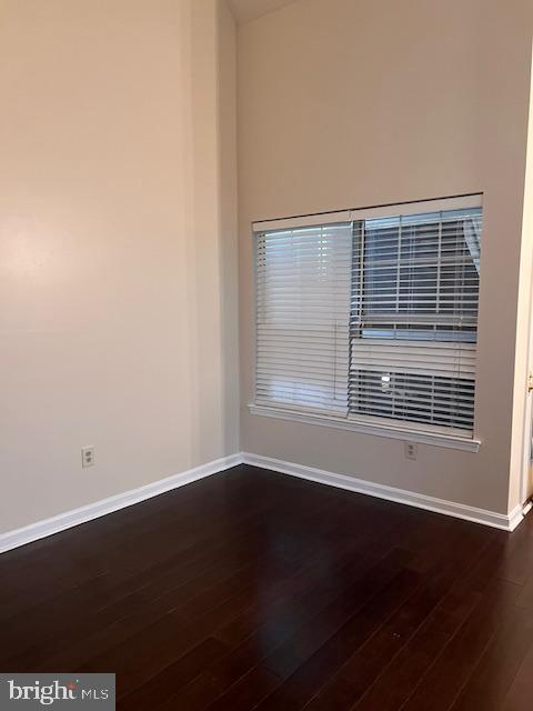 14119 Bowsprit Lane, Unit 312 Laurel, MD 20707 - Photo 5 of 24 a view of an empty room with wooden floor and a window